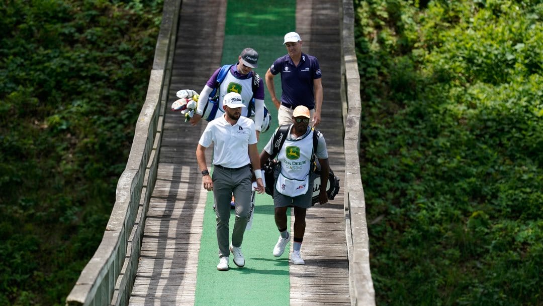 Hayden Buckley, left, walks with his caddie across a bridge on the fifth fairway during the third round of the John Deere Classic golf tournament, Saturday, July 2, 2022, at TPC Deere Run in Silvis, Ill.