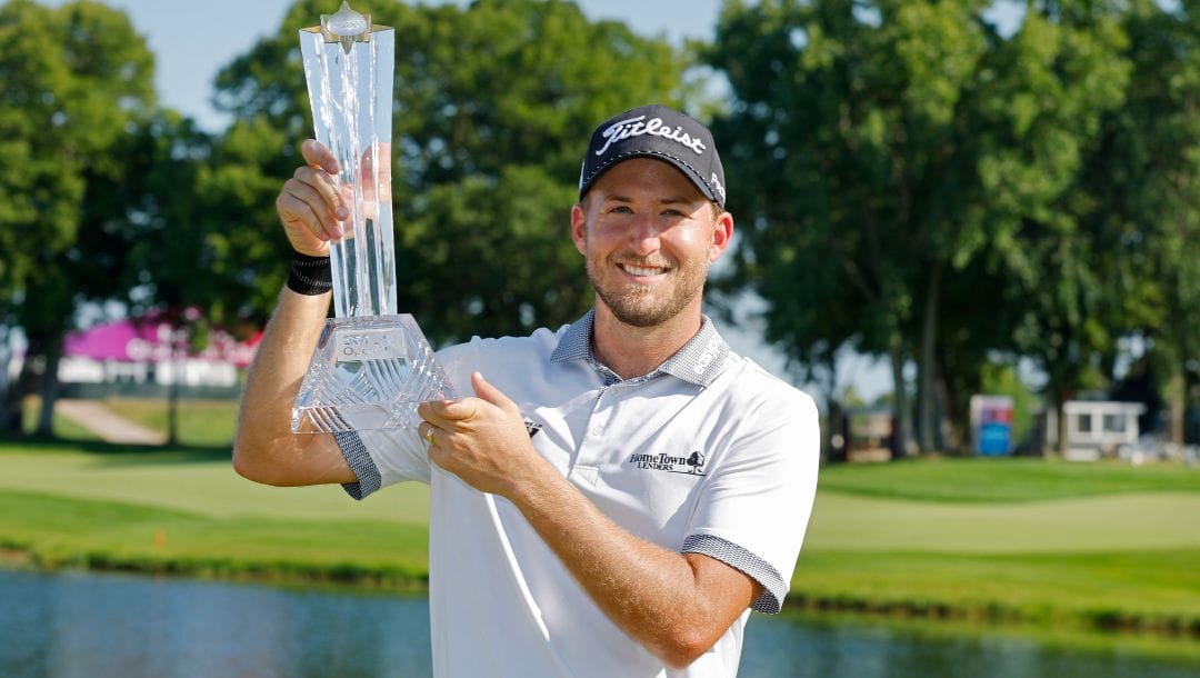 Lee Hodges holds up the trophy after winning the 3M Open golf tournament at the Tournament Players Club Sunday, July 30, 2023, in Blaine, Minn.