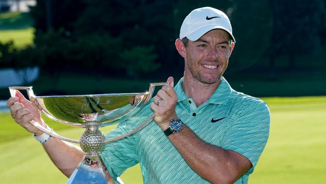 Rory McIlroy, of Northern Ireland, holds the championchip trophy after winning the final round of the Tour Championship golf tournament at East Lake Golf Club, Sunday, Aug. 28, 2022, in Atlanta.
