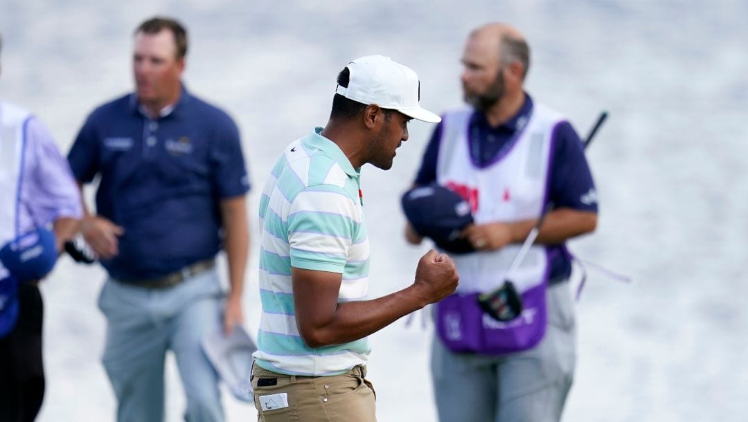 Tony Finau celebrates his win in the 3M Open golf tournament at the Tournament Players Club in Blaine, Minn., Sunday, July 24, 2022.