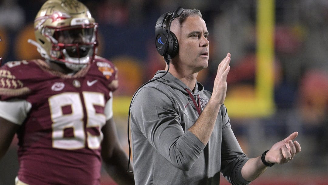 Florida State coach Mike Norvell, right, applauds after a successful 2-point conversion during the first half of the team's Cheez-It Bowl NCAA college football game against Oklahoma, Thursday, Dec. 29, 2022, in Orlando, Fla. After signs of change a couple of years ago, it looks like the ACC is back to normal with defending champion Clemson and former powerhouse Florida State expected to dominate once more.