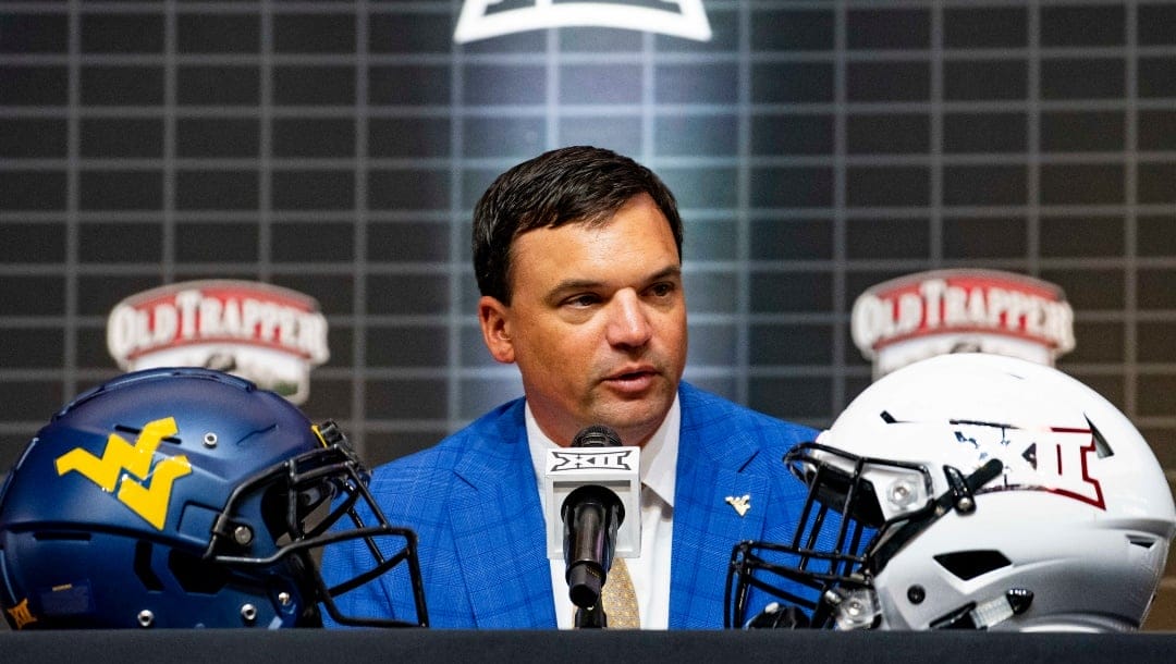 West Virginia head football coach Neal Brown answers questions from reporters at the NCAA college football Big 12 media days in Arlington, Texas, Thursday, July 13, 2023. (AP Photo/Emil T. Lippe)
