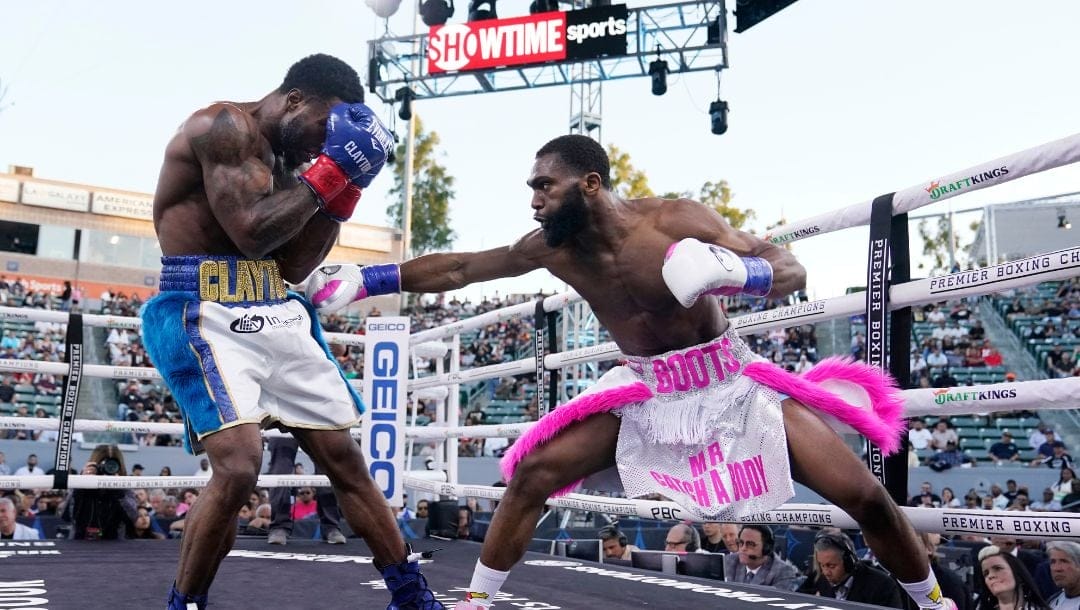 Jaron Ennis, right, throws a punch at Custio Clayton during a welterweight boxing bout Saturday, May 14, 2022, in Carson, Calif.