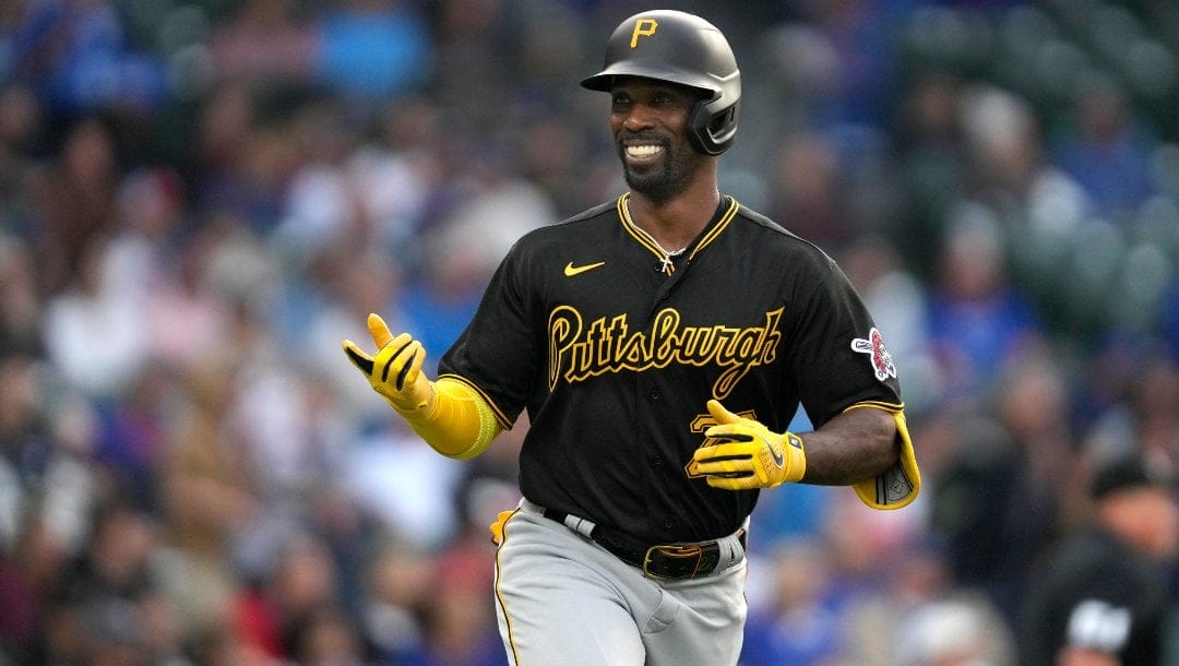 Pirates player Andrew McCutchen smiling while running.