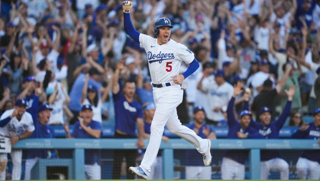 Los Angeles Dodgers' Freddie Freeman (5) celebrates after Will Smith (16) hit a home run during the eighth inning of a baseball game against the Houston Astros in Los Angeles, Sunday, June 25, 2023. They both scored.