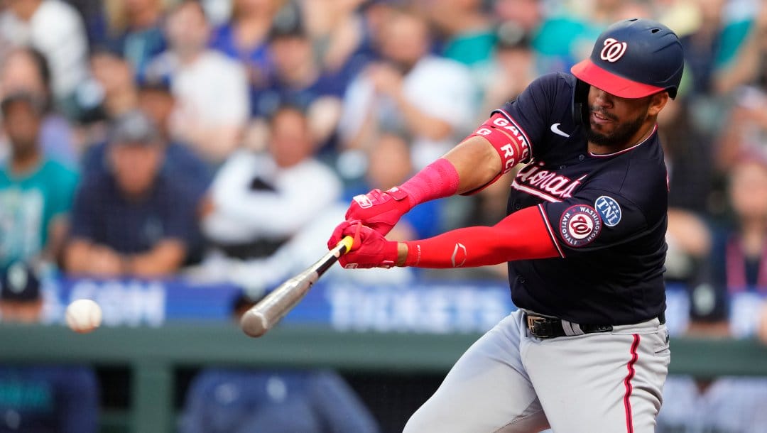 Washington Nationals' Luis Garcia hits an RBI single against the Seattle Mariners to score CJ Abrams during the third inning of a baseball game Monday, June 26, 2023, in Seattle.