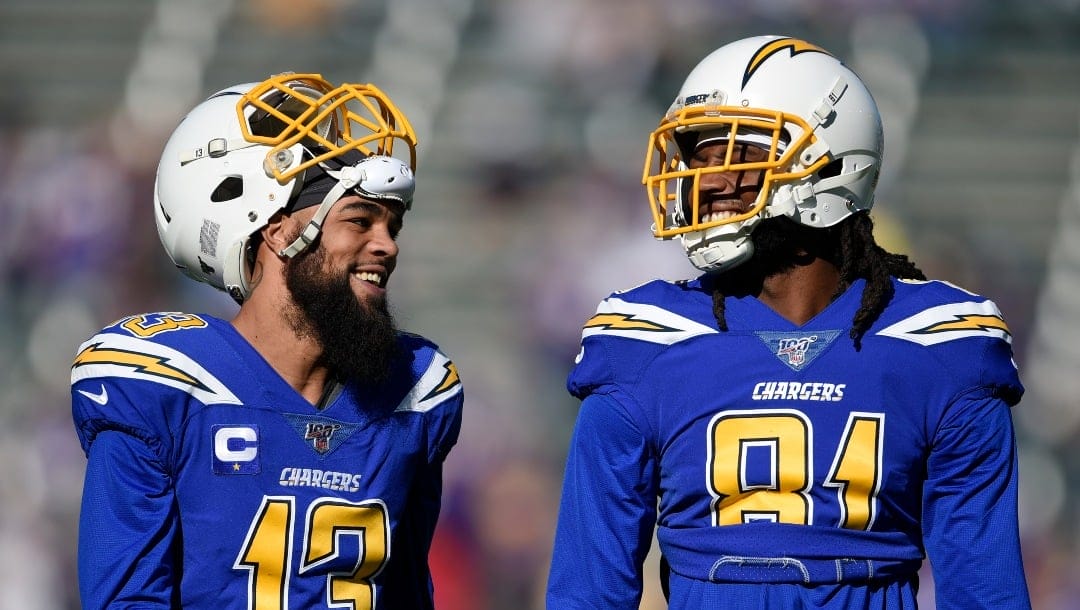 FILE - Los Angeles Chargers wide receivers Keenan Allen, left, and Mike Williams chat before an NFL football game against the Minnesota Vikings in Carson, Calif., Sunday, Dec. 15, 2019. The Chargers have already restructured contracts for wide receivers Keenan Allen and Mike Williams, but will need to restructure more or cut a couple players before they can begin addressing their needs. (AP Photo/Kelvin Kuo, File)