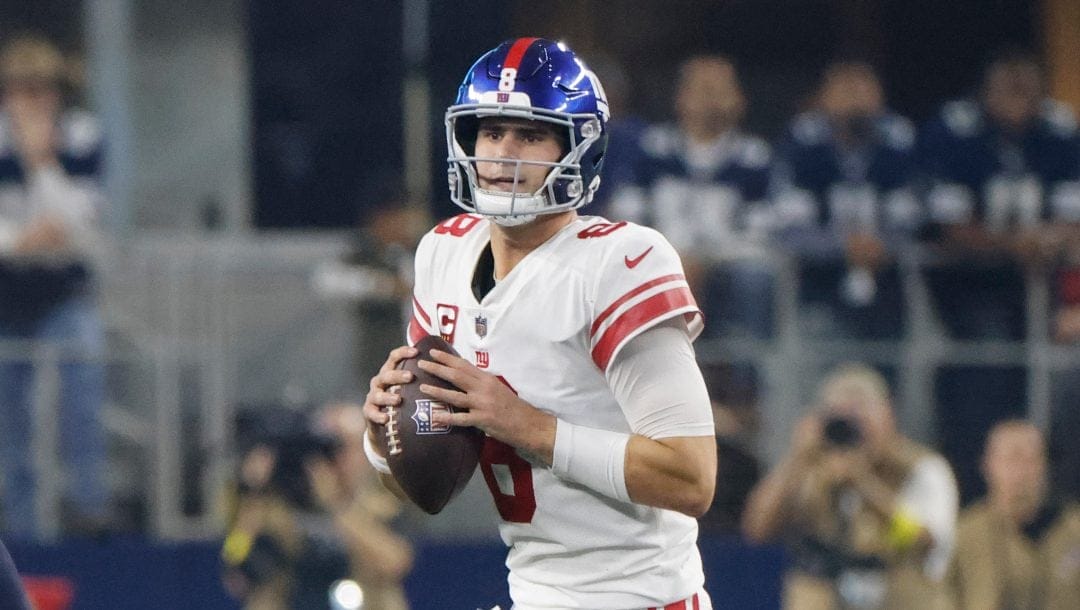 Giants player number 8 holding a NFL game ball.