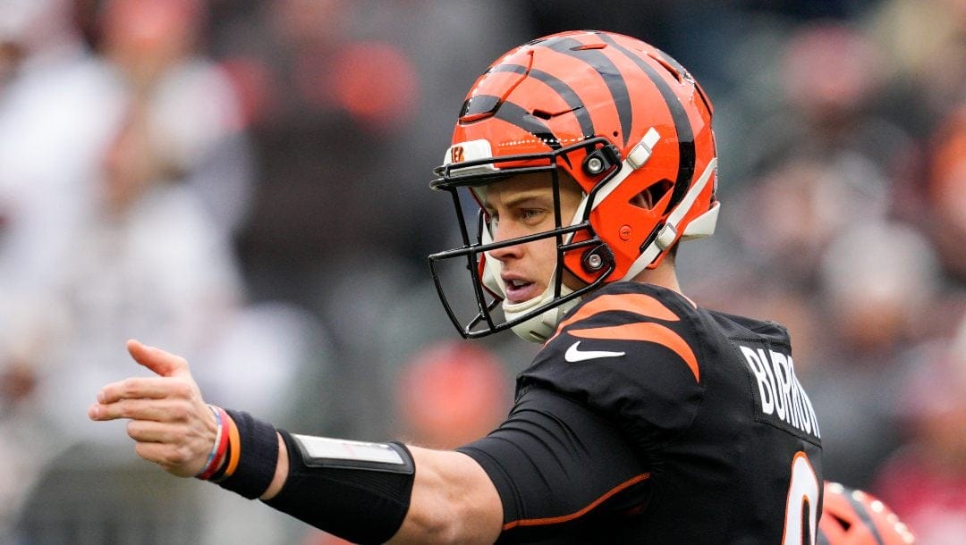 Bengals player in an orange and black uniform is pointing.
