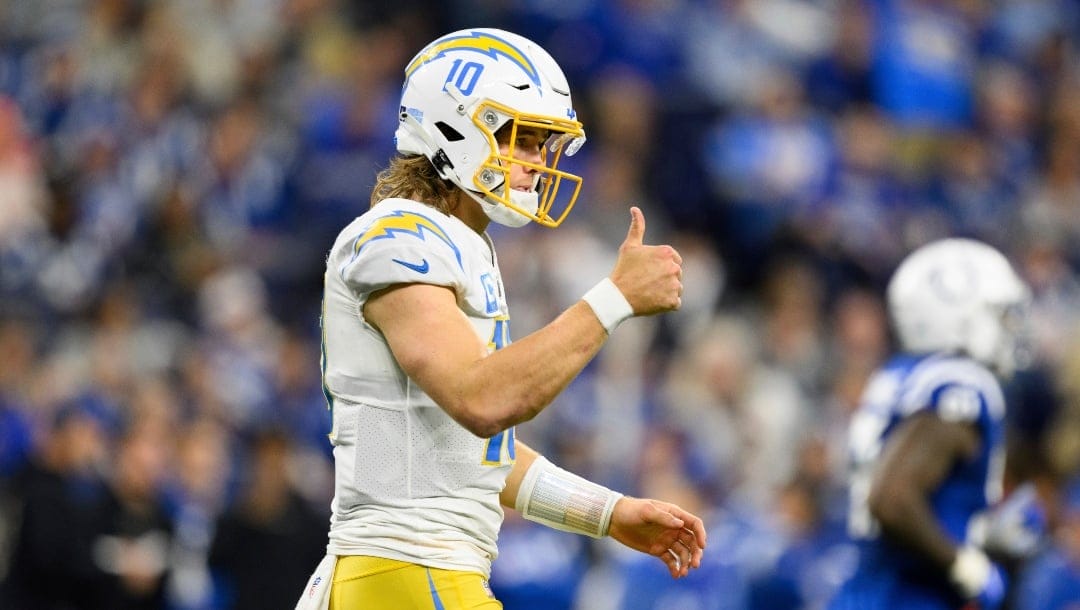 Los Angeles Chargers quarterback Justin Herbert (10) gives the sideline a thumbs up after a first down throw during an NFL football game against the Indianapolis Colts, Monday, Dec. 26, 2022, in Indianapolis. (AP Photo/Zach Bolinger)