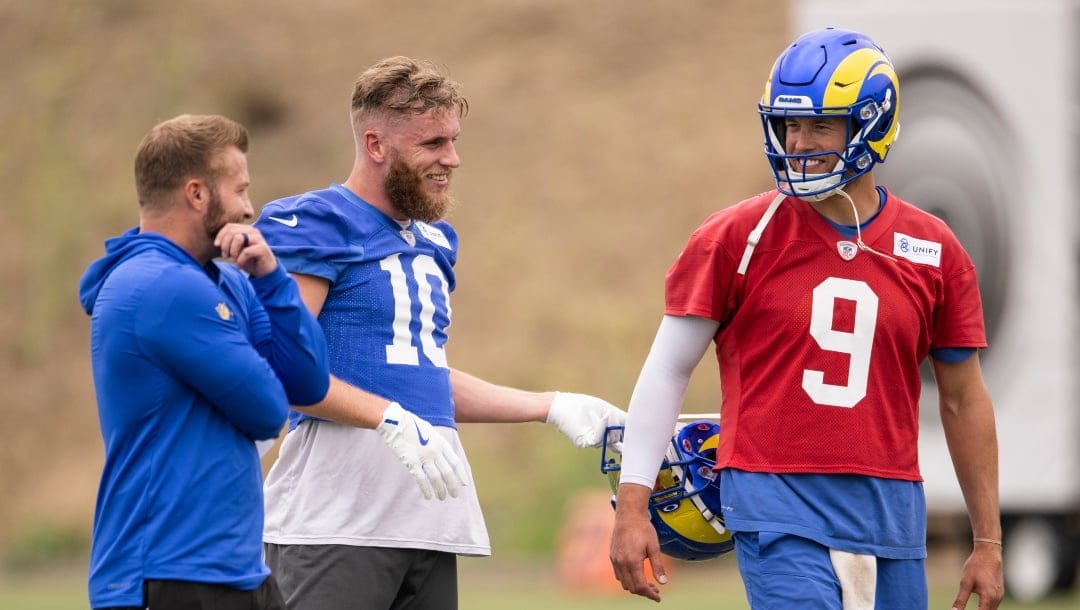 Los Angeles Rams coach Sean McVay, wide receiver Cooper Kupp (10) and quarterback Matthew Stafford (9) talk during the NFL football team's camp Wednesday, June 14, 2023, in Thousand Oaks, Calif. (AP Photo/Kyusung Gong)