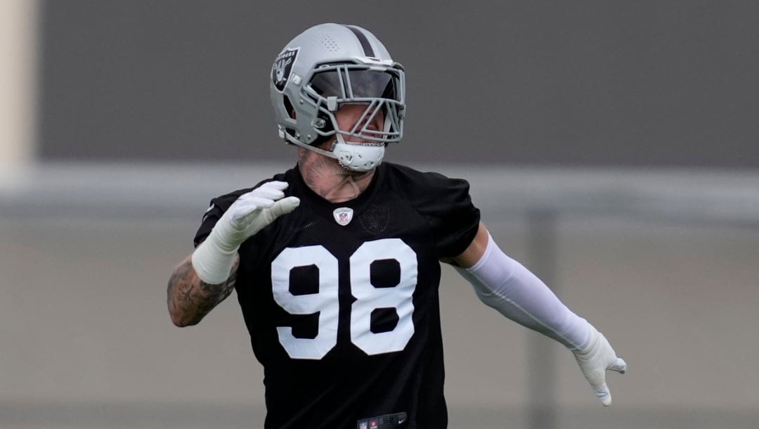 Las Vegas Raiders defensive end Maxx Crosby (98) warms up during an NFL football practice at the team's training facility Wednesday, June 7, 2023, in Henderson, Nev. (AP Photo/John Locher)