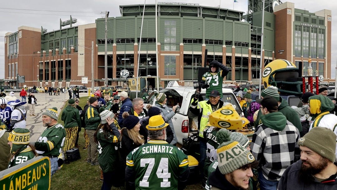 Fans tailgate outside Lambeau Field before an NFL football game between the Dallas Cowboys and the Green Bay Packers, Nov. 13, 2022, in Green Bay, Wis. The NFL draft will be coming to Green Bay and historic Lambeau Field in 2025. NFL officials announced Monday, May 22, 2023, during the league’s spring meetings that the 2025 draft will take place in Green Bay. Activities will go on inside and around field and Titletown, the collection of shops and restaurants surrounding the stadium.