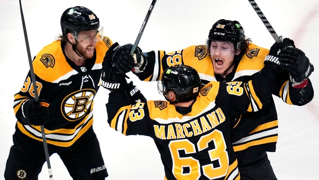 Boston Bruins left wing Brad Marchand (63) is congratulated by Boston Bruins left wing Tyler Bertuzzi, right, and right wing David Pastrnak (88) after his goal off Florida Panthers goaltender Sergei Bobrovsky during the second period of Game 5 in the first round of the NHL hockey playoffs, Wednesday, April 26, 2023, in Boston. At right is Florida Panthers defenseman Marc Staal. (AP Photo/Charles Krupa)