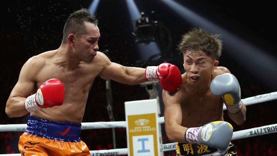 Philippines' Nonito Donaire, left, sends a left to Japan's Naoya Inoue in the fourth round of their World Boxing Super Series.