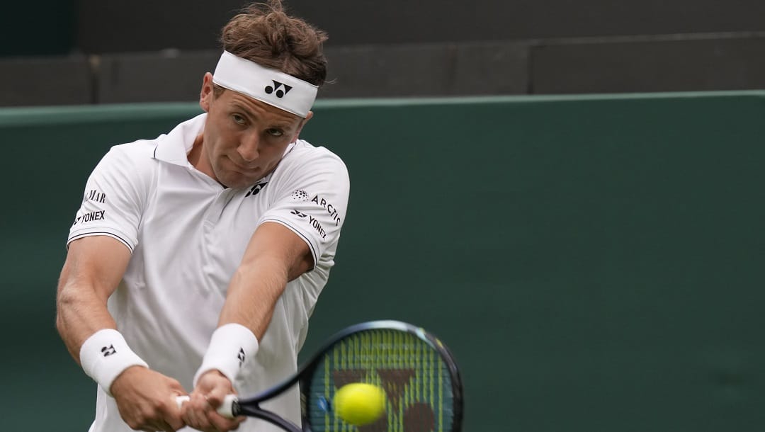 Norway's Casper Ruud plays a return to Laurent Lokoli of France during the first round men's singles match on day one of the Wimbledon tennis championships in London, Monday, July 3, 2023.