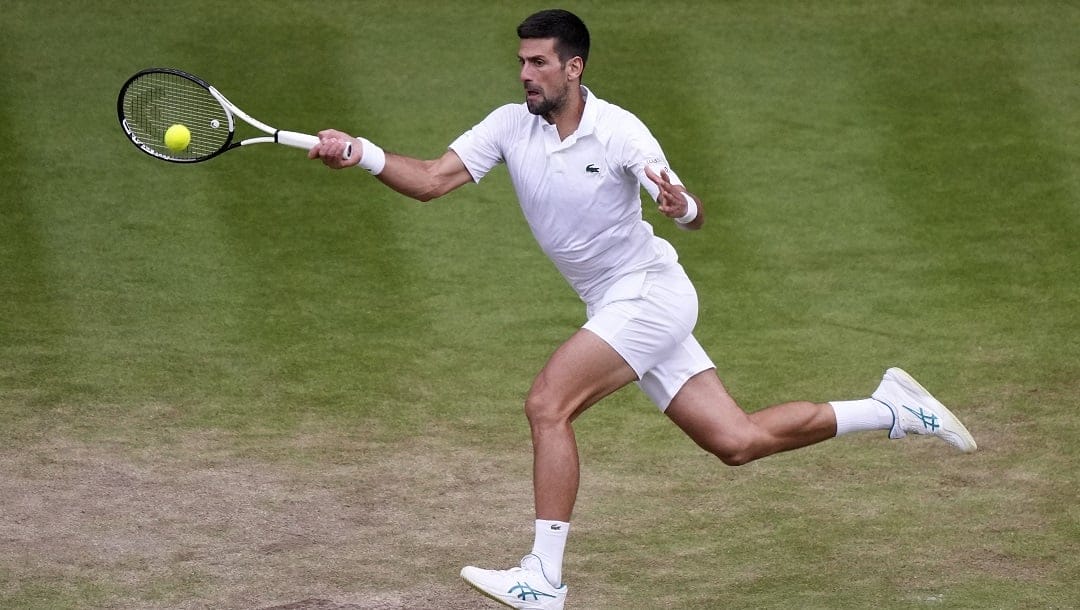 Serbia's Novak Djokovic returns to Russia's Andrey Rublev in a men's singles match on day nine of the Wimbledon tennis championships in London, Tuesday, July 11, 2023.