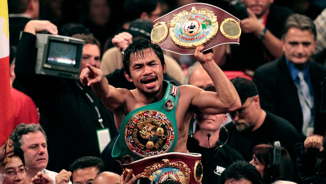 Manny Pacquiao, of the Philippines, holds the championship belt at the finish of his WBO welterweight boxing title fight.
