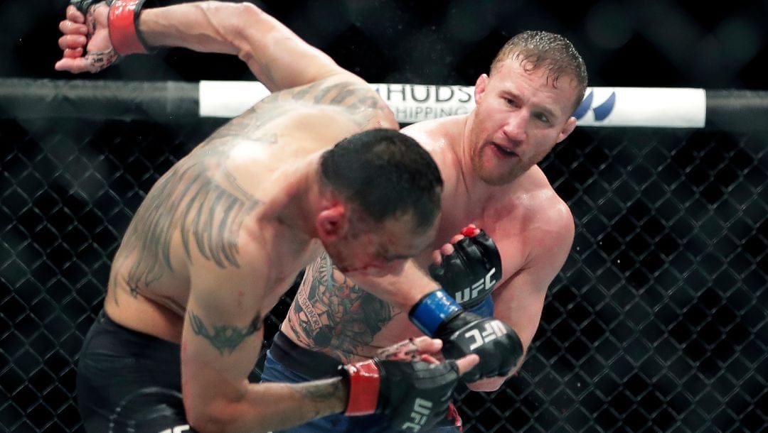 FILE - In this May 10, 2020, file photo, Tony Ferguson, left, falls backward after taking a punch from Justin Gaethje.