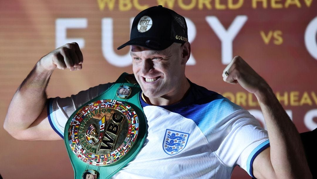 FILE - WBC heavyweight boxing champion Tyson Fury poses with his championship belt after the official weigh-in for his fight.