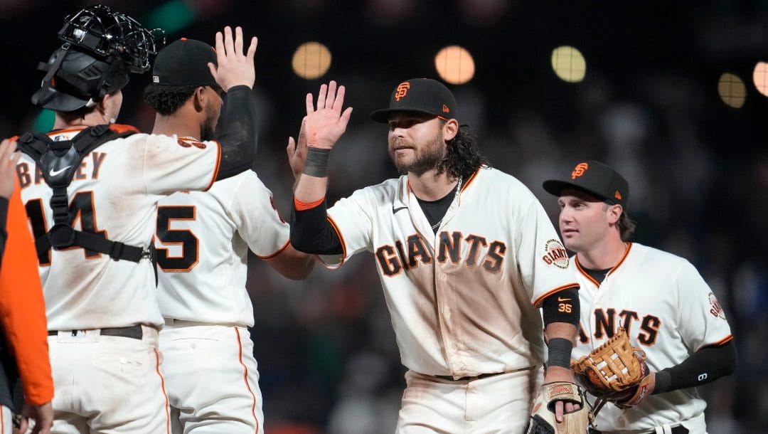 San Francisco Giants' Patrick Bailey, Camilo Doval, Brandon Crawford and Casey Schmitt, from left, celebrate after the Giants defeated the Arizona Diamondbacks in a baseball game in San Francisco, Wednesday, Aug. 2, 2023.