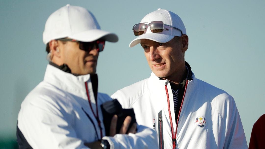 U.S. team captain Jim Furyk, right, stands alongside vice-captain Zach Johnson on the driving range at Le Golf National in Guyancourt, outside Paris, France, Tuesday, Sept. 25, 2018. Furyk has been named U.S. captain for the 2024 Presidents Cup at Royal Montreal.