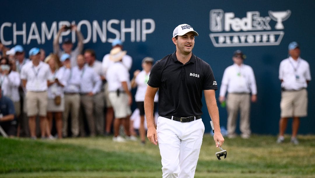 Patrick Cantlay smiles on the 18th green during the final round of the BMW Championship golf tournament at Wilmington Country Club, Sunday, Aug. 21, 2022, in Wilmington, Del.