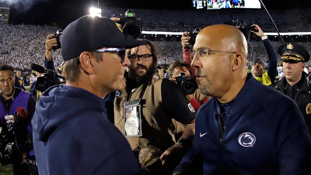 Penn State coach James Franklin, right, and Michigan coach Jim Harbaugh, left, meet after an NCAA college football game in State College, Pa., Saturday, Oct. 19, 2019. Penn State won 28-21.