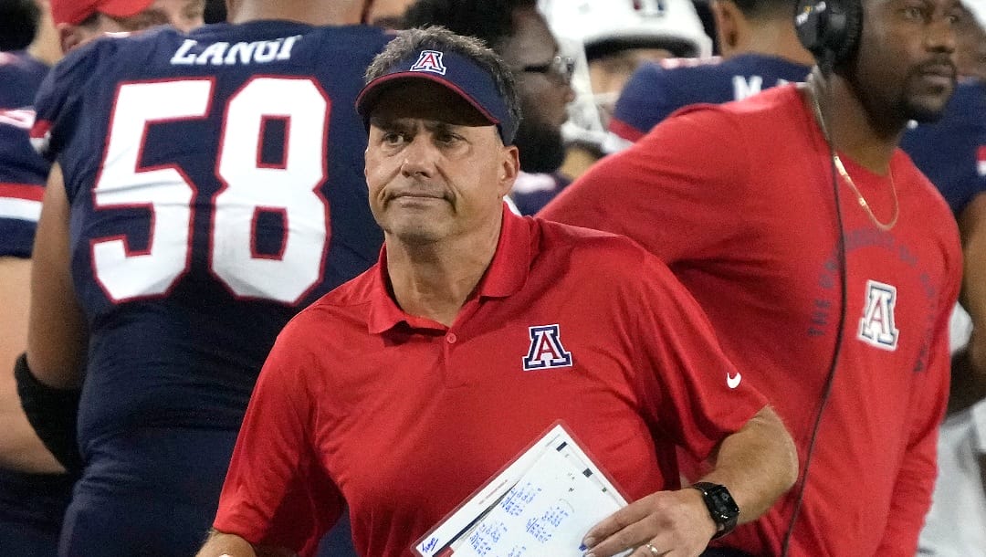 Arizona coach Jedd Fisch runs to call for a timeout during the second half of the team's NCAA college football game against Colorado, Saturday, Oct. 1, 2022, in Tucson, Ariz. (AP Photo/Rick Scuteri)
