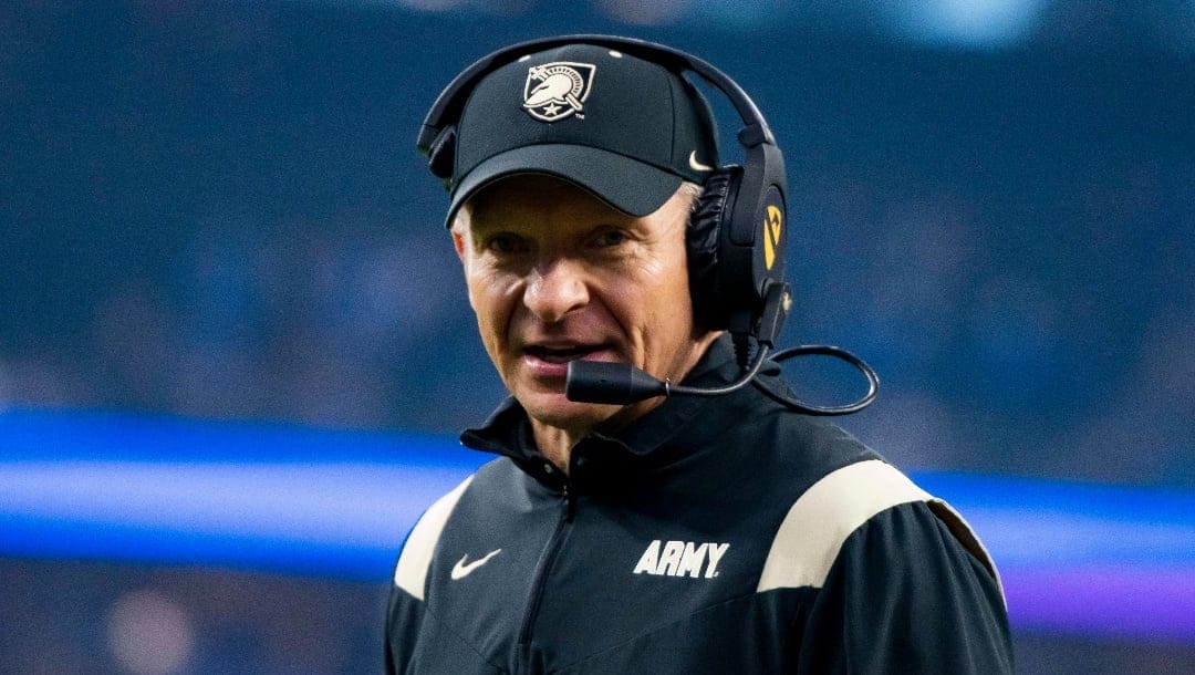 Army Black Knights head coach Jeff Monken converses with other coaches on his headset about the next play during an NCAA college football game against Air Force in Arlington, Texas, Saturday, Nov. 5, 2022. (AP Photo/Emil Lippe)