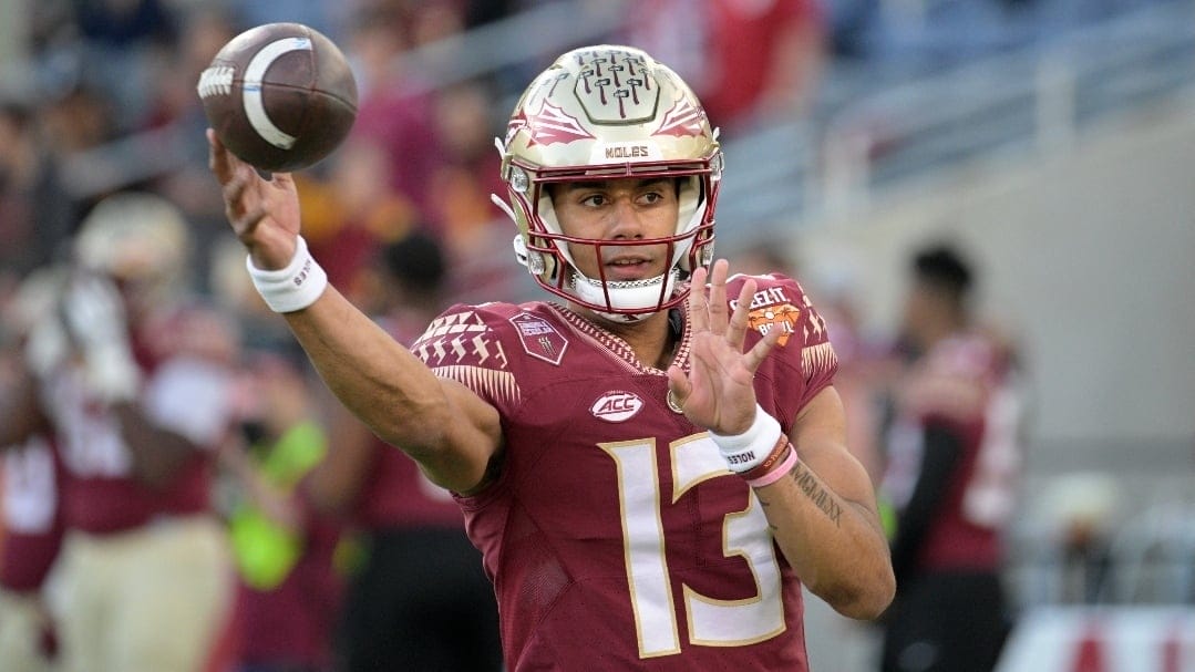 Florida State quarterback Jordan Travis (13) warms up before the Cheez-It Bowl NCAA college football game against Oklahoma, Thursday, Dec. 29, 2022, in Orlando, Fla.