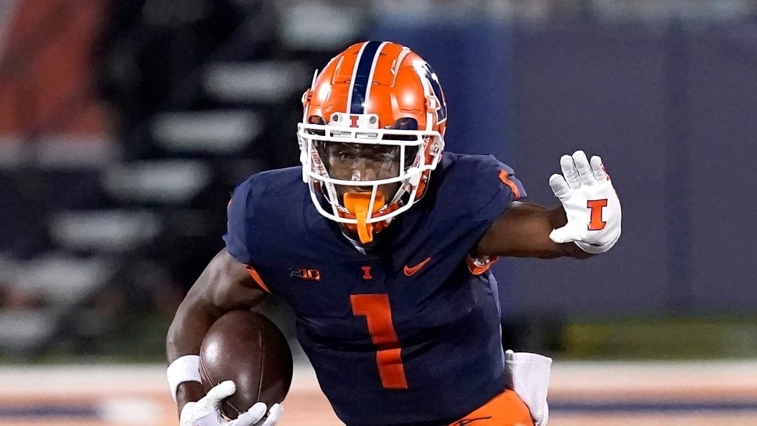 Illinois wide receiver Isaiah Williams carries the ball during an NCAA college football game against Chattanooga Thursday, Sept. 22, 2022, in Champaign, Ill. (AP Photo/Charles Rex Arbogast)