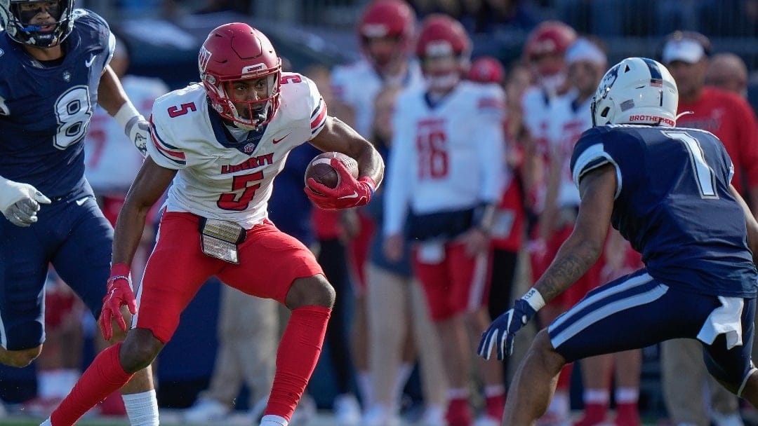 Liberty wide receiver Noah Frith (5) runs with the ball during the first half of an NCAA college football game against Connecticut in East Hartford, Conn., Saturday, Nov. 12, 2022. (AP Photo/Bryan Woolston)