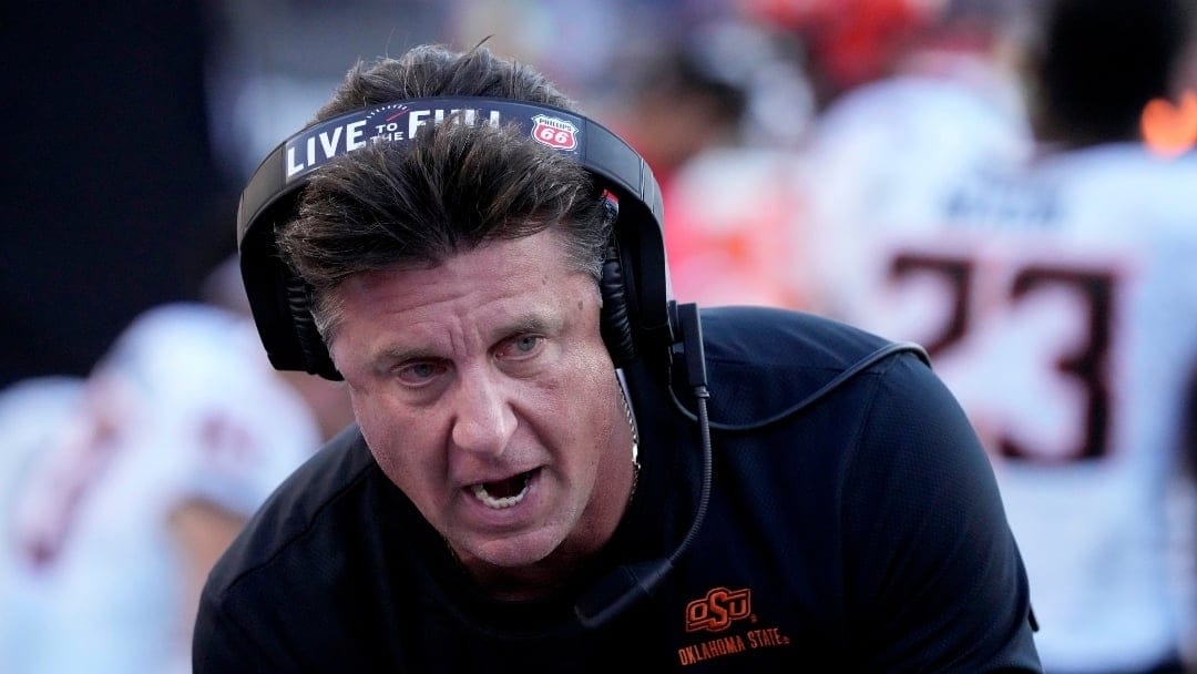 Oklahoma State head coach Mike Gundy talks to his players during the second half of an NCAA college football game against Kansas State Saturday, Oct. 29, 2022, in Manhattan, Kan. (AP Photo/Charlie Riedel)