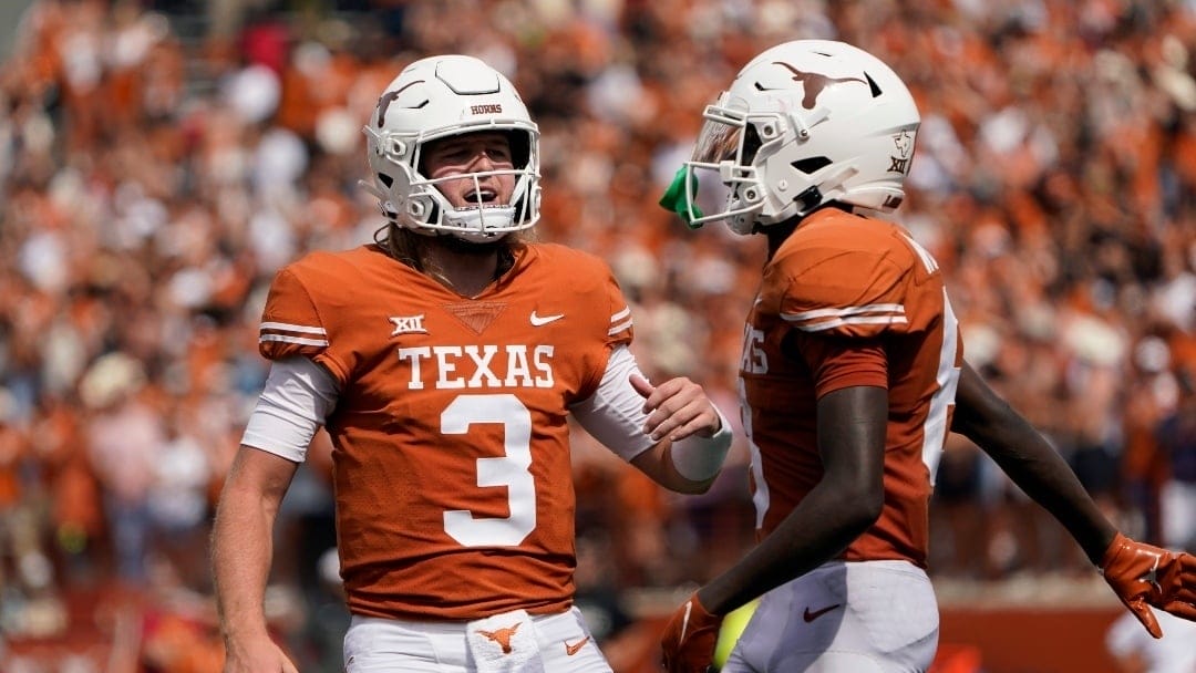 Texas quarterback Quinn Ewers (3) and wide receiver Xavier Worthy (8) celebrate after they connected on a touchdown pass against Iowa State during the second half of an NCAA college football game, Saturday, Oct. 15, 2022, in Austin, Texas. (AP Photo/Eric Gay)