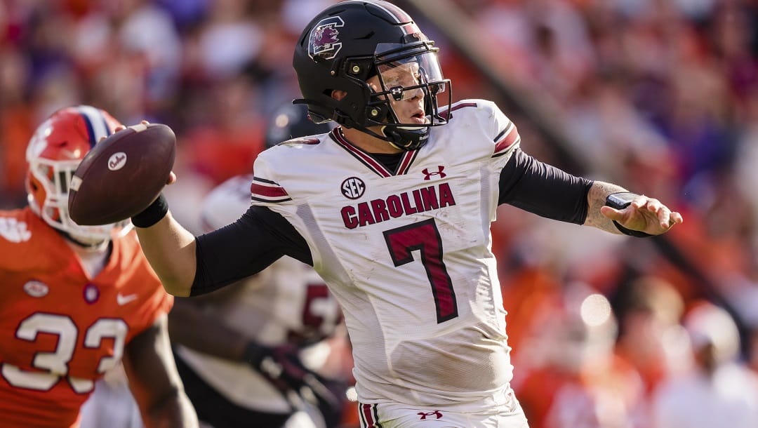 South Carolina quarterback Spencer Rattler (7) throws against Clemson during an NCAA college football game Nov. 26, 2022, in Clemson, S.C. Rattler needed answers before deciding on the NFL. He got all the right ones from his teammates and new offensive coordinator Dowell Loggains to stick around for another season.