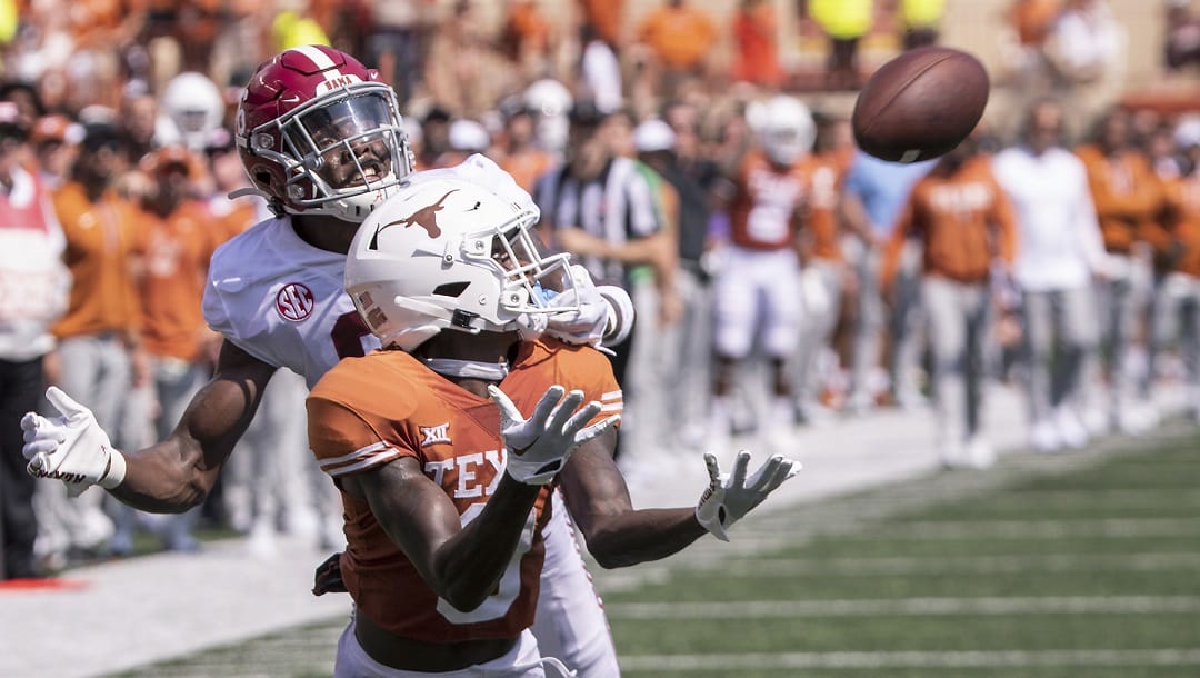 Texas wide receiver Xavier Worthy (8) pulls down a reception as Alabama defensive back Khyree Jackson (6) grabs his face mask defending on the play during the first half of an NCAA college football game, Saturday, Sept. 10, 2022, in Austin, Texas. Alabama defeated Texas 20-19.