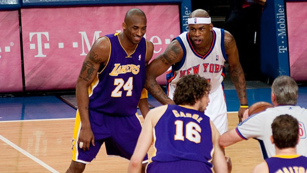 Kobe Bryant of the Los Angeles Lakers and Al Harrington of the New York Knicks during the start of an NBA game.