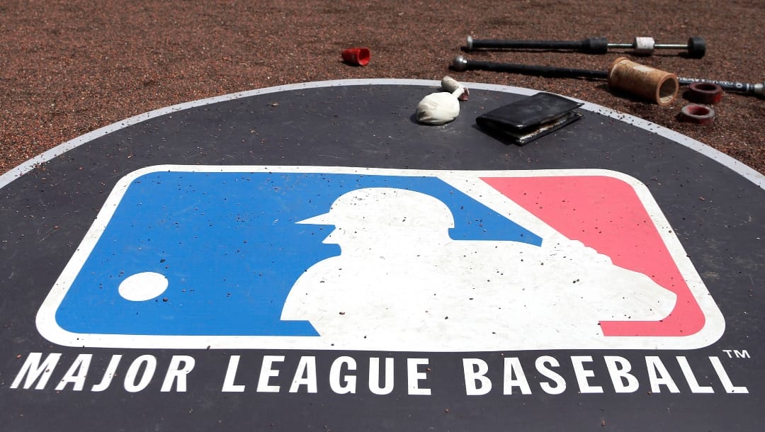 FILE - The Major League Baseball logo serves as the visitor's on-deck circle before a baseball game between the Chicago White Sox and the Cleveland Indians, April 24, 2013, in Chicago. Major League Baseball has canceled plans to play regular-season games in Paris in 2025 after failing to find a promoter, two people familiar with the decision told The Associated Press, Thursday, Nov. 16, 2023. (AP Photo/Charles Rex Arbogast, File)