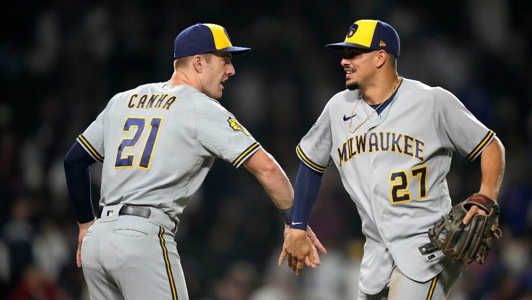 Milwaukee Brewers' Mark Canha (21) and Willy Adames celebrate the team's 6-2 win over the Chicago Cubs in a baseball game Monday, Aug. 28, 2023, in Chicago. (AP Photo/Charles Rex Arbogast)