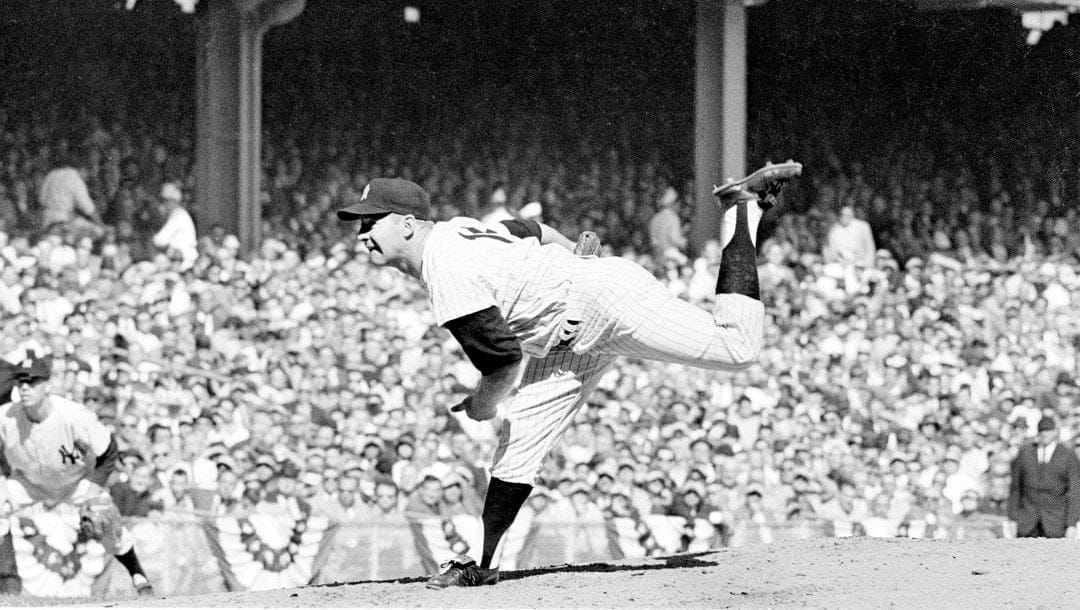 In this Oct. 8, 1960 file photo, New York Yankees pitcher Whitey Ford throws against the Pittsburgh Pirates in the third World Series game at Yankee Stadium in New York.