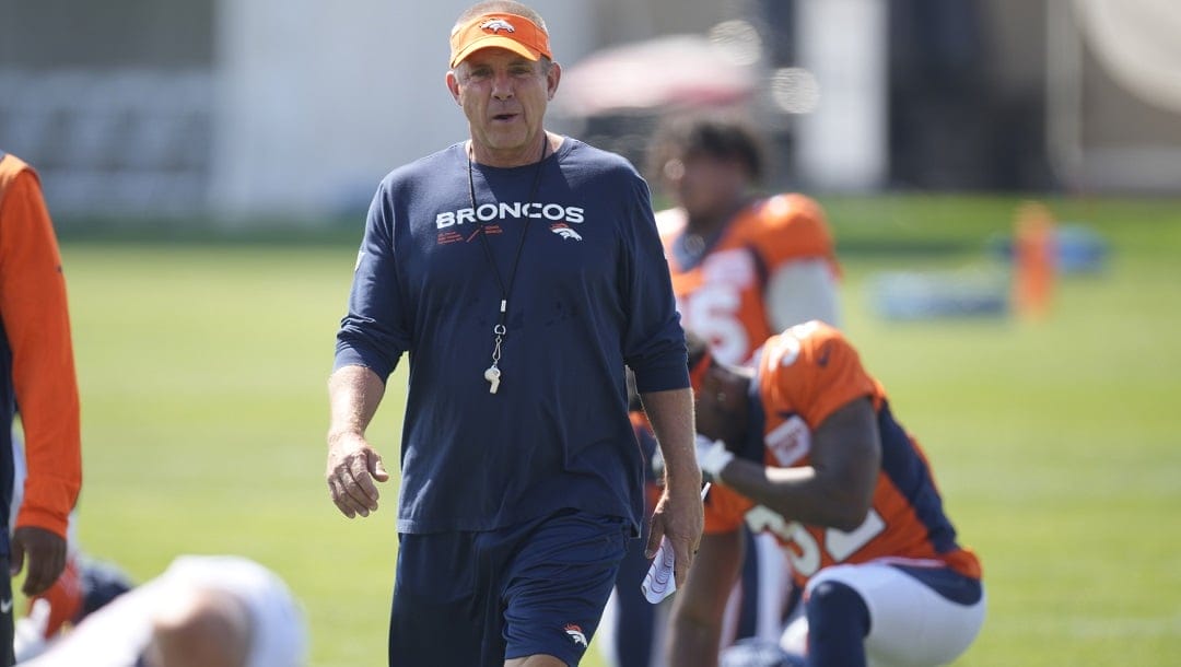 Denver Broncos head coach Sean Payton looks on as players stretch during an NFL football training camp at the team's headquarters Monday, July 31, 2023, in Centennial, Colo.