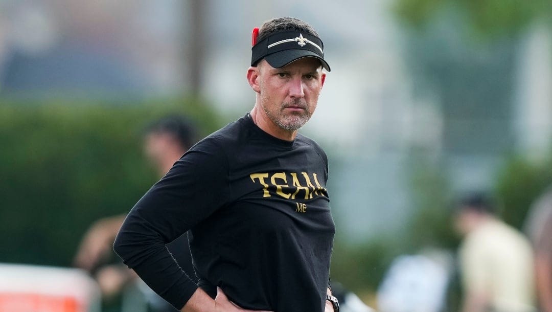 New Orleans Saints head coach Dennis Allen walks through stretches at the team's NFL football training camp in Metairie, La., Wednesday, July 26, 2023. (AP Photo/Gerald Herbert)