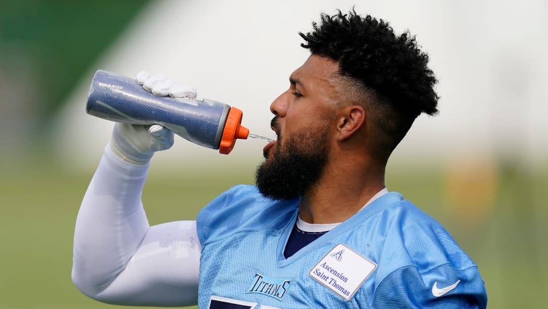 Tennessee Titans outside linebacker Harold Landry III takes a drink during an NFL football training camp practice Wednesday, July 26, 2023, in Nashville, Tenn. (AP Photo/George Walker IV)
