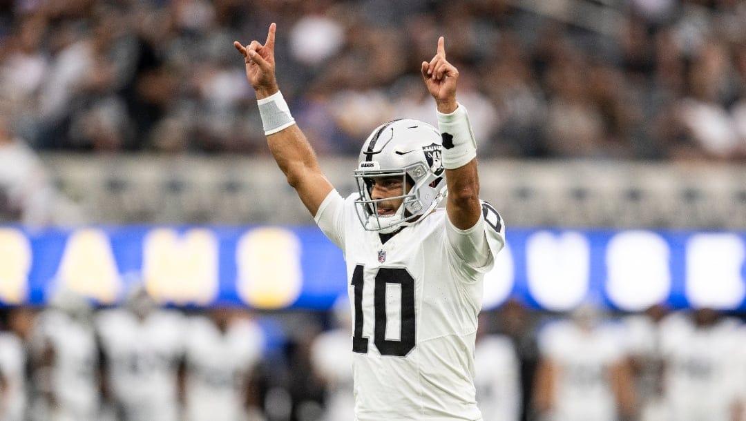 Las Vegas Raiders quarterback Jimmy Garoppolo (10) reacts on the team's touchdown during an NFL preseason football game against the Los Angeles Rams, Saturday, Aug. 19, 2023, in Inglewood, Calif.