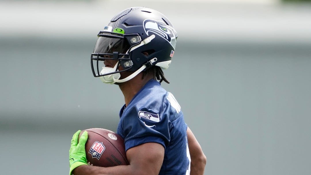Seattle Seahawks running back Kenneth Walker III (9) holds a football during drills Monday, May 22, 2023, at the team's NFL football training facility in Renton, Wash. (AP Photo/Lindsey Wasson)