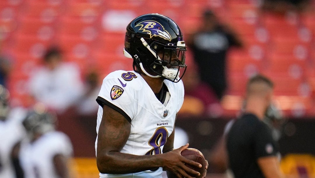 Baltimore Ravens quarterback Lamar Jackson works out prior to an NFL preseason football game, Monday, Aug. 21, 2023, in Landover, Md. The Commanders won 29-28. (AP Photo/Julio Cortez)