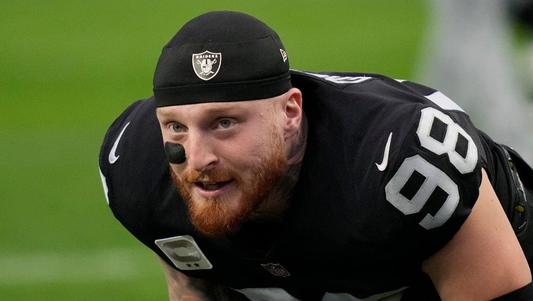 Las Vegas Raiders defensive end Maxx Crosby (98) warms up before an NFL football game against the Kansas City Chiefs, Wednesday, Jan. 11, 2023, in Las Vegas.