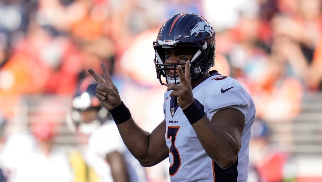 Denver Broncos quarterback Russell Wilson signals at the line of scrimmage during the first half of an NFL preseason football game against the San Francisco 49ers, Saturday, Aug. 19, 2023, in Santa Clara, Calif. (AP Photo/Godofredo A. Vásquez)