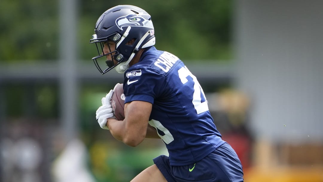 Seattle Seahawks running back Zach Charbonnet (26) holds the football during drills Monday, May 22, 2023, at the team's NFL football training facility in Renton, Wash.